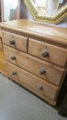 A two over two pine chest of drawers.