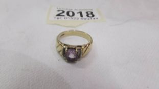 An oval amethyst ring set with diamond shoulders, 375 9ct gold, size O half.