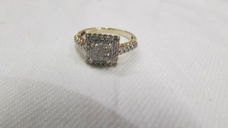 A diamond ring set with Princess cuts to centre and round brilliant cuts to edges and shoulders in - Image 2 of 3