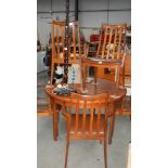 A teak dining table and four chairs.