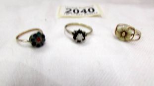 A 9ct gold ring, a silver ring and an unmarked ring.