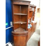 An open top corner cupboard.