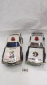 Two large tin plate battery operated American police cars - Trans-Am and Tornado.