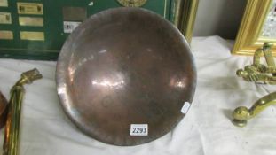 An arts and crafts copper bowl with stylised base.