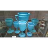 A blue glass jug and five goblets.