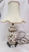 An oriental style table lamp with shade.