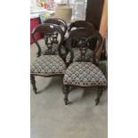 A set of four dining chairs.
