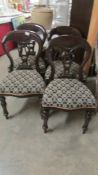 A set of four dining chairs.