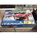 A boxed Scalextric V12 Super cars Aston Martin Lotus,