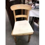 A kitchen chair with seat cushion