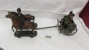 A pre-war tin plate military carriage with hard plastic figures and horses, no visible makers marks.