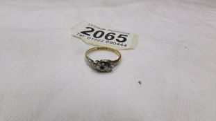 An 18ct gold and platinum ring with small diamonds, (approximately total weight 2.7 grams). size M.