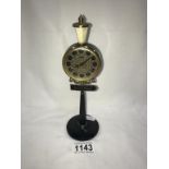 A vintage Rhythm alarm clock in form of a Moulin Rouge street lamp