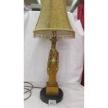 An art deco style figural table lamp with shade.