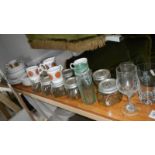 A shelf of vintage ceramics and glass ware.