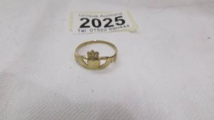 A 9ct gold Claddagh ring, size T. 1.9 grams.