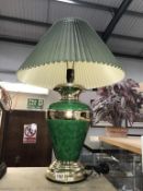 A green and gilded table lamp with shade