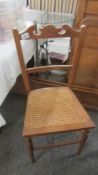 A cane seated bedroom chair. (Collect only).