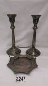 A pair of silver candlesticks and a small silver tray.