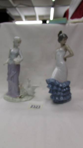 A boxed NAO by Lladro Flamenco dancer and another unboxed and unmarked figure of a lady with a duck.