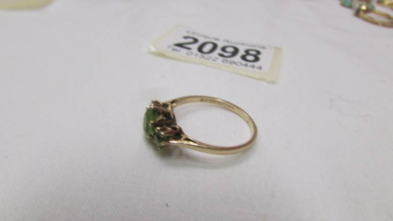 A 9ct gold ring set three peridot, size O half. - Image 2 of 2