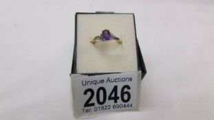 A 9ct gold ring set amethyst coloured stone, size P.