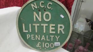 An N C C No Litter Penalty £100 metal sign.