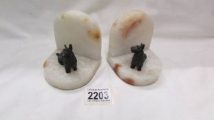 A pair of art deco spelter scottie dog marble book ends.