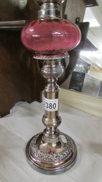 A telescopic 'candlestick' oil lamp with cranberry glass font. (collect only). - Image 2 of 3