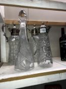 3 claret jugs with silver plated fittings and a cut glass decanter (chipped to rim)
