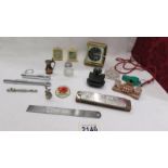 A mixed lot including travel alarm clock, harmonica, Acme whistle etc.