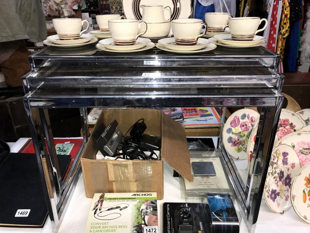 A chrome framed vintage nest of tables with smoked glass tops