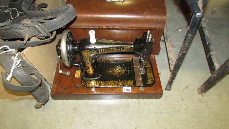 A cased 'New Ideal' sewing machine. (Collect only).