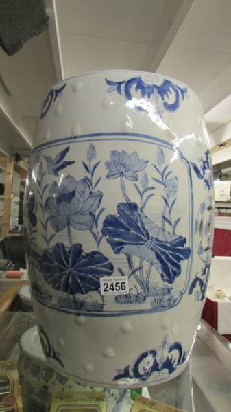 A large blue and white ceramic garden seat.