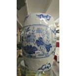 A large blue and white ceramic garden seat.