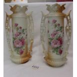 A pair of Victorian floral decorated twin handled vases.