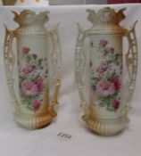 A pair of Victorian floral decorated twin handled vases.