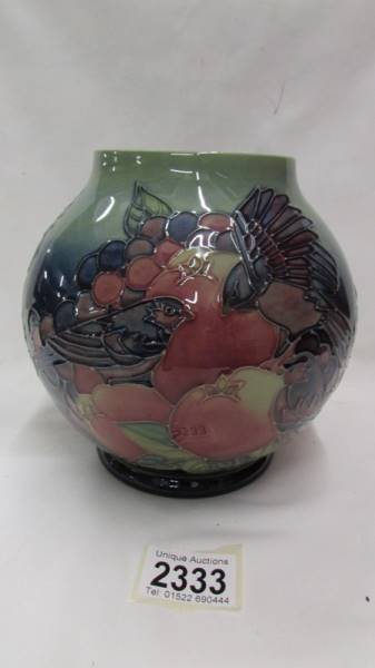 A Moorcroft Vase in a birds eating fruit pattern.
