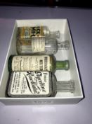 4 vintage bottles with paper label advertising