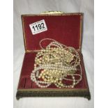 A jewellery box containing pearl necklaces