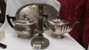 A silver plate tray, two silver plate teapots and a silver plate candlestick.