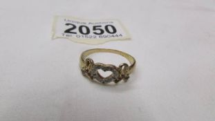 A 9ct gold heart and bows ring, size U.
