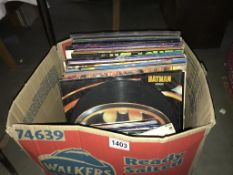 A box of LP's and 45's including Batman picture disc, Happy Mondays, Bill Withers, Blur etc.