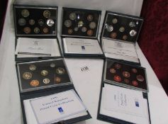 Five boxed Royal Mint uncirculated coin collections.