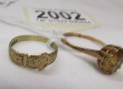 A 9ct gold buckle ring, size O, 1.8 grams and a 9ct gold ring set yellow stone, size P.