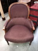 A mahogany framed balloon back armchair with burgundy upholstery