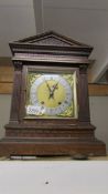 An 8 day mantel clock with pendulum and key.