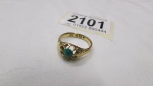An 18ct gold ring set jade?, size N half.