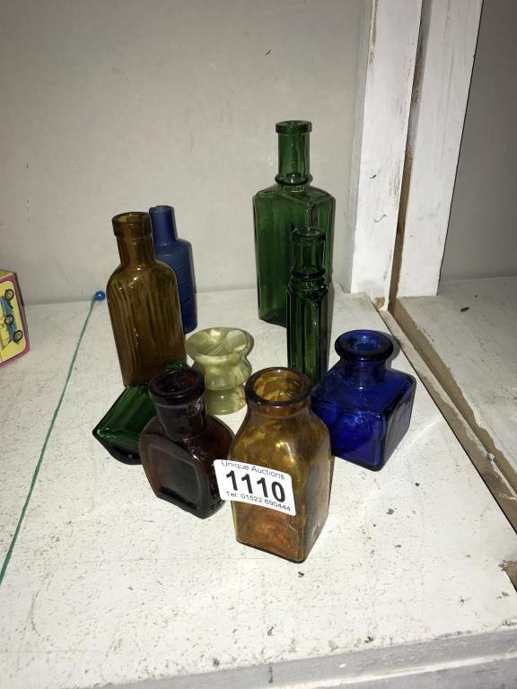 A quantity of small blue, green & brown bottles including Jeyes etc.