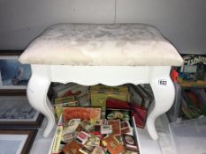 A white painted dressing table stool with cream fabric top